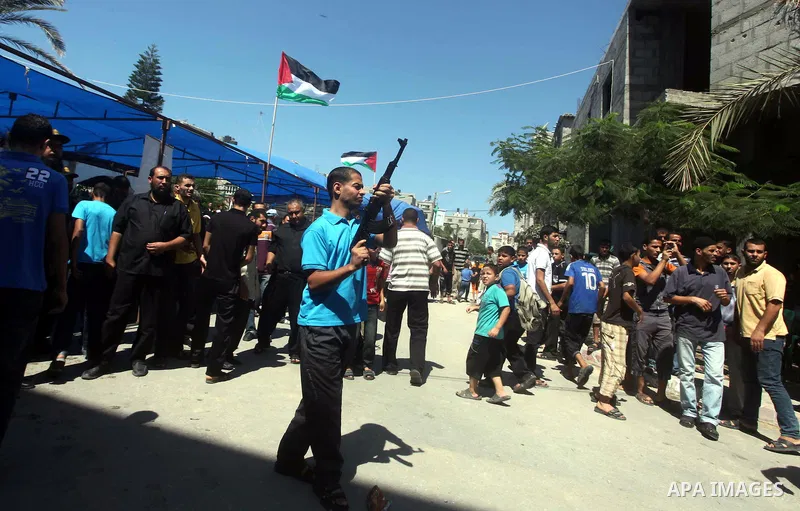 A relative of Palestinian security official Ashraf Saleh shoots during his funeral in Rafah in the southern Gaza Strip September 20, 2012. Israel killed two Palestinian security officials, one of them Saleh, in the Hamas...