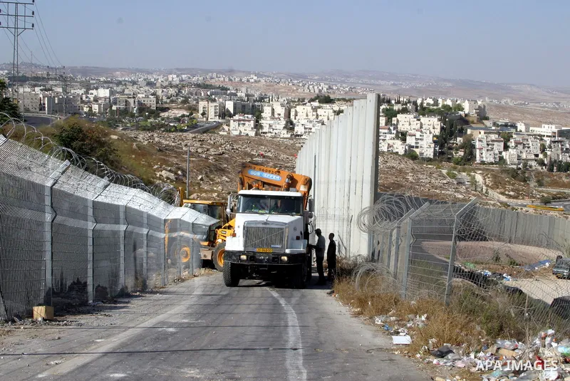 An Israeli bulldozer works to sealing off the Ras Khamis Checkpoint northen jerusalem on Sept. 20, 2012. The Israeli Ministry of Defence has announced its plans to seal off one of two checkpoints through which the 65,000...