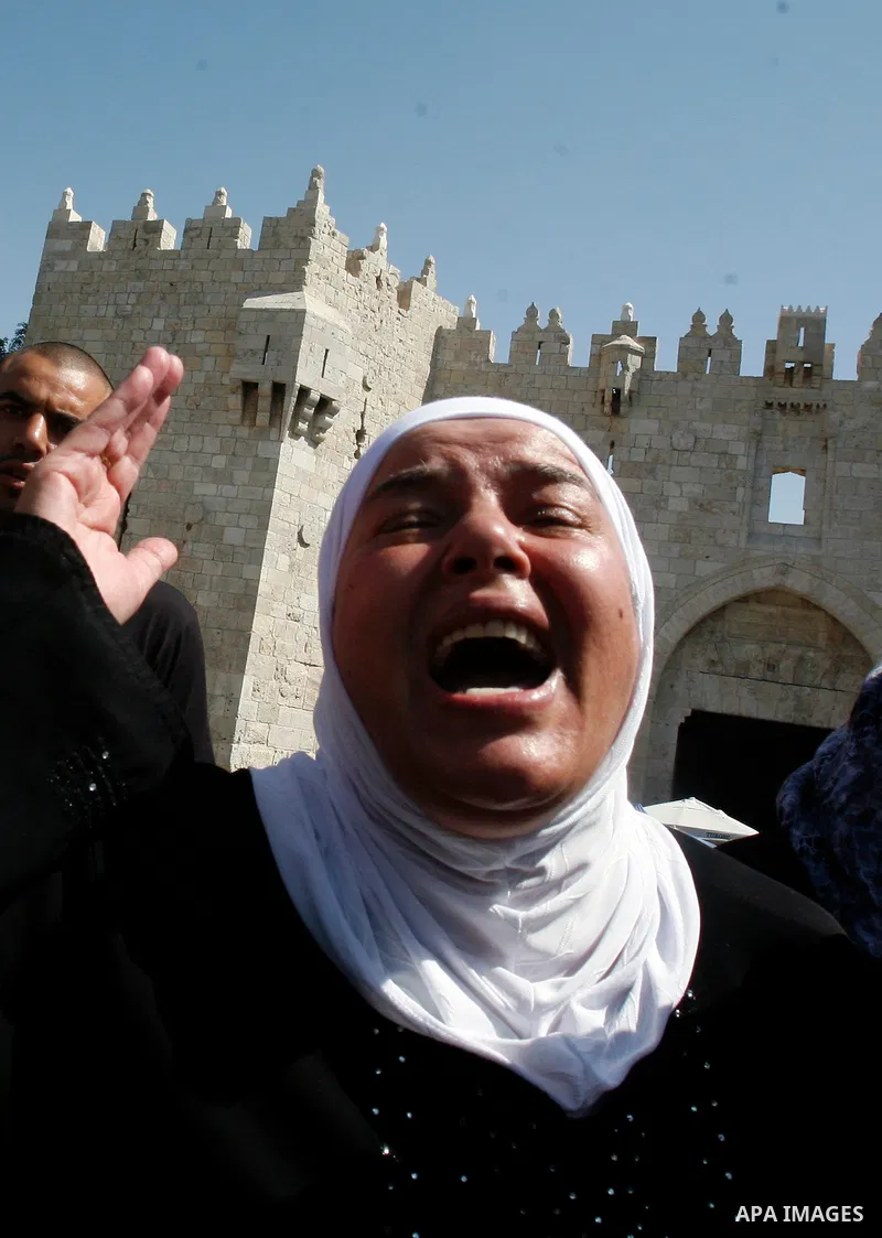 A Palestinian woman shouts slogans during a protest against an anti-Islam movie made in the U.S. and French cartoons said to insult the Prophet Muhammad in Jerusalem's Old City, Sept. 21, 2012. Photo by Mahfouz Abu Turk