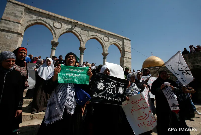 Palestinians wave flags and shout slogans during a protest against an anti-Islam movie made in the U.S. and French cartoons said to insult the Prophet Muhammad in Jerusalem's Old City, Sept. 21, 2012. Photo by Mahfouz Ab...