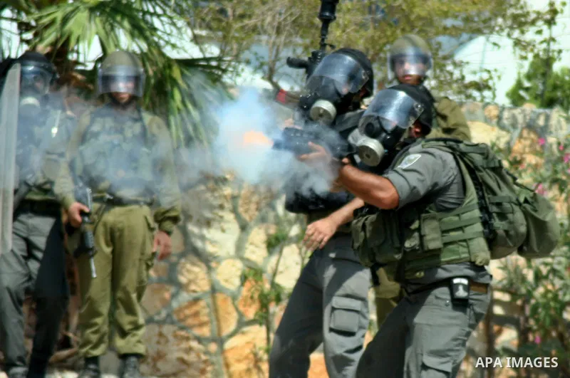 Israeli soldiers fire tear gas toward Palestinian protesters during a demonstration against the expropriation of Palestinian land by Israel in the village of Kfar Qaddum, near the West Bank city of Nablus, on september 2...
