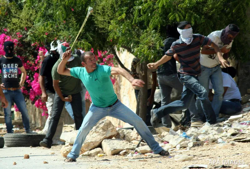 Palestinian protesters throw stones at Israeli soldiers during a demonstration against the expropriation of Palestinian land by Israel in the village of Kfar Qaddum, near the West Bank city of Nablus, on september 21, 20...