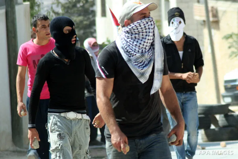 Palestinian protesters throw stones at Israeli soldiers during a demonstration against the expropriation of Palestinian land by Israel in the village of Kfar Qaddum, near the West Bank city of Nablus, on september 21, 20...