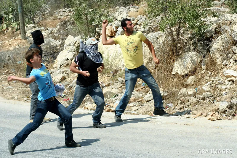 Palestinian protesters throw stones at Israeli soldiers during a demonstration against the expropriation of Palestinian land by Israel in the village of Kfar Qaddum, near the West Bank city of Nablus, on september 21, 20...