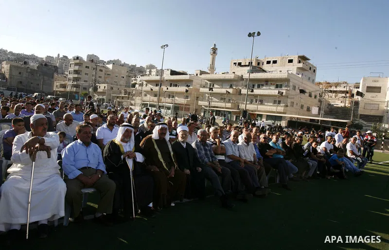 Palestinians chant slogans during a gathering denouncing an US-produced amateur film mocking Islam's Prophet Mohammed and cartoons published in a French satirical magazine Charlie Hebdo, in the Issawiya district of Arab...