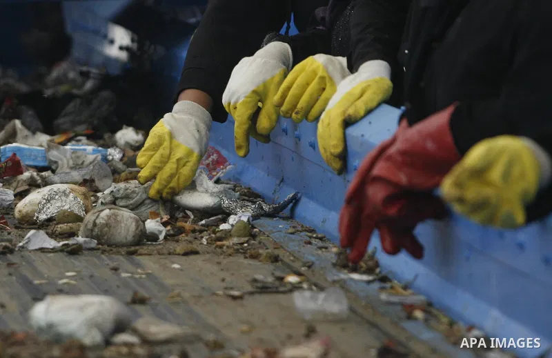 Palestinian women sort solid waste for production compost in station in Rafah in the southern Gaza Strip, on Sep. 23, 2012 Some Palestinians, driven by poverty exacerbated by the Israeli blockade and lack of employment o...