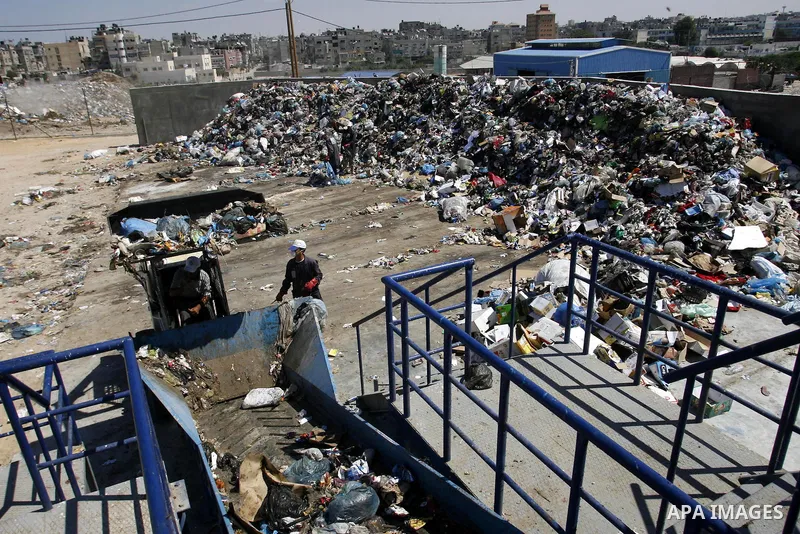 Palestinians collect rubbish to production compost in station in Rafah in the southern Gaza Strip, on Sep. 23, 2012 Some Palestinians, driven by poverty exacerbated by the Israeli blockade and lack of employment opportun...