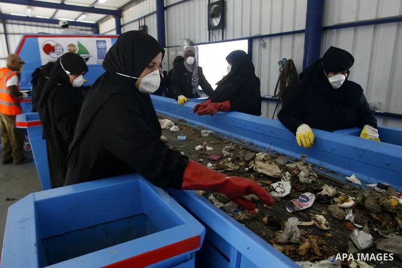 Palestinian women sort solid waste for production compost in station in Rafah in the southern Gaza Strip, on Sep. 23, 2012 Some Palestinians, driven by poverty exacerbated by the Israeli blockade and lack of employment o...