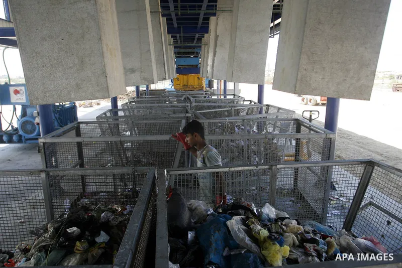 Palestinians collect rubbish to production compost in station in Rafah in the southern Gaza Strip, on Sep. 23, 2012 Some Palestinians, driven by poverty exacerbated by the Israeli blockade and lack of employment opportun...