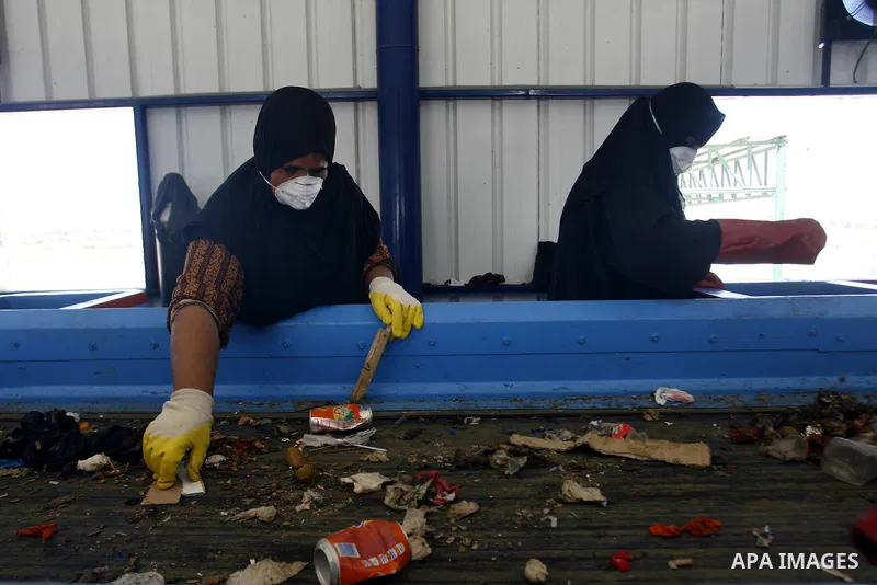 Palestinian women sort solid waste for production compost in station in Rafah in the southern Gaza Strip, on Sep. 23, 2012 Some Palestinians, driven by poverty exacerbated by the Israeli blockade and lack of employment o...
