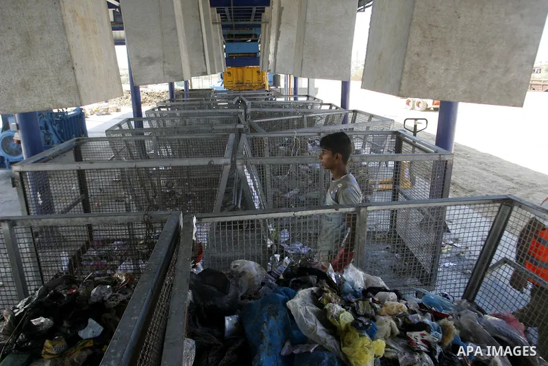 Palestinians collect rubbish to production compost in station in Rafah in the southern Gaza Strip, on Sep. 23, 2012 Some Palestinians, driven by poverty exacerbated by the Israeli blockade and lack of employment opportun...