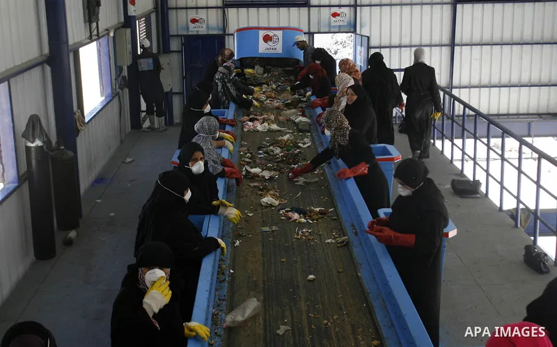 Palestinian women sort solid waste for production compost in station in Rafah in the southern Gaza Strip, on Sep. 23, 2012 Some Palestinians, driven by poverty exacerbated by the Israeli blockade and lack of employment o...