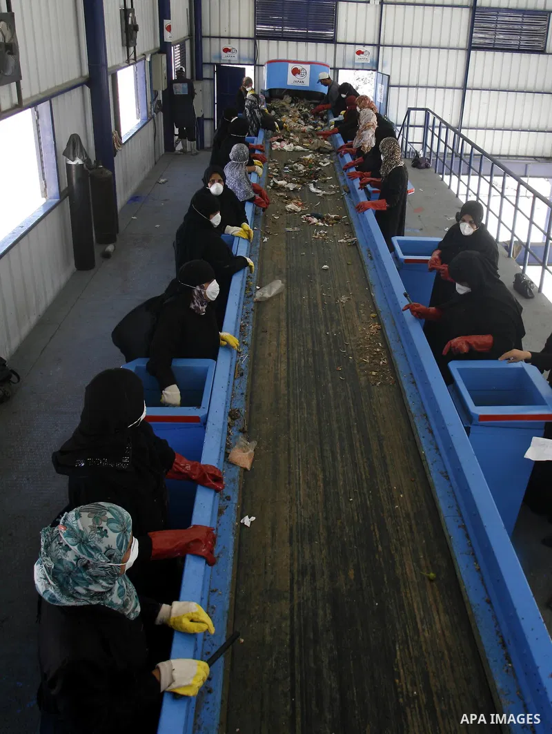Palestinian women sort solid waste for production compost in station in Rafah in the southern Gaza Strip, on Sep. 23, 2012 Some Palestinians, driven by poverty exacerbated by the Israeli blockade and lack of employment o...