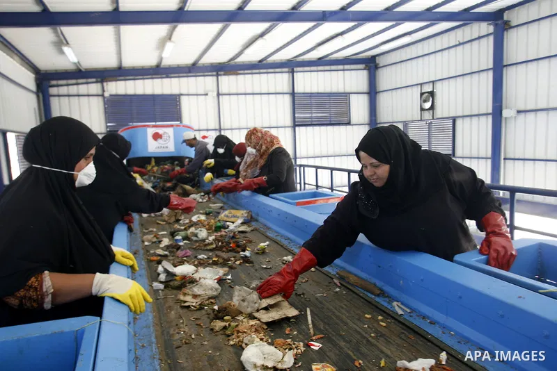 Palestinian women sort solid waste for production compost in station in Rafah in the southern Gaza Strip, on Sep. 23, 2012 Some Palestinians, driven by poverty exacerbated by the Israeli blockade and lack of employment o...
