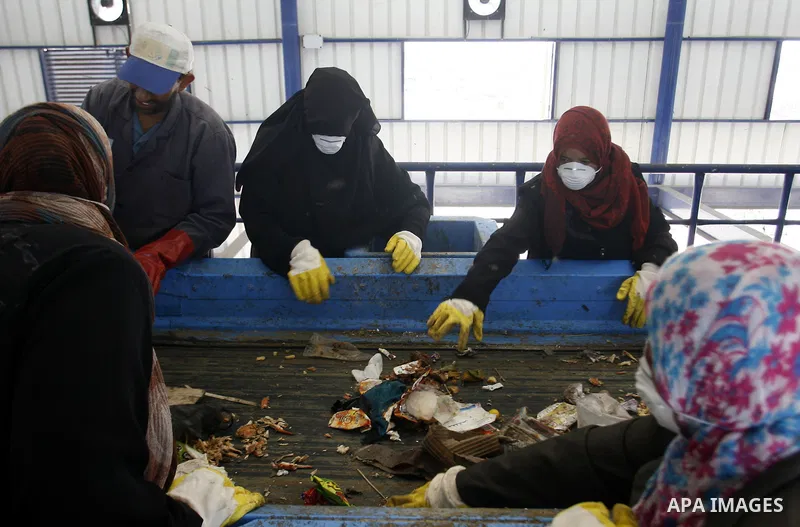 Palestinian women sort solid waste for production compost in station in Rafah in the southern Gaza Strip, on Sep. 23, 2012 Some Palestinians, driven by poverty exacerbated by the Israeli blockade and lack of employment o...