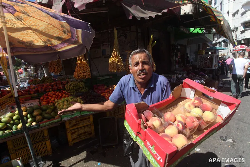 A Palestinian vendor displays fruits at a market in Gaza city, Sept. 23, 2012. The ministry of agriculture in Gaza government decided stop import fruits from Israel except apples and bananas to support the local fruits p...