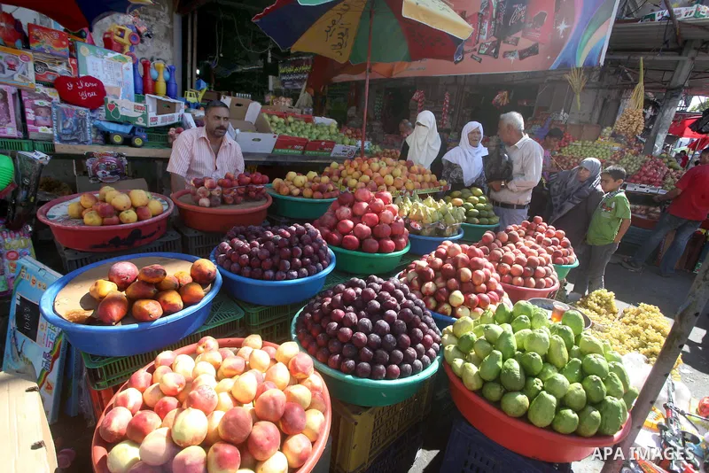 A Palestinian vendor displays fruits at a market in Gaza city, Sept. 23, 2012. The ministry of agriculture in Gaza government decided stop import fruits from Israel except apples and bananas to support the local fruits p...
