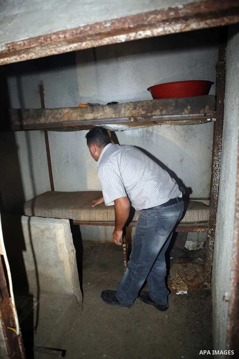 Palestinian plain clothed security inspects a room built under a house in the West Bank village of Urif, south of the northern city of Nablus on September 23, 2012. Palestinian security believe a network of tunnels, room...