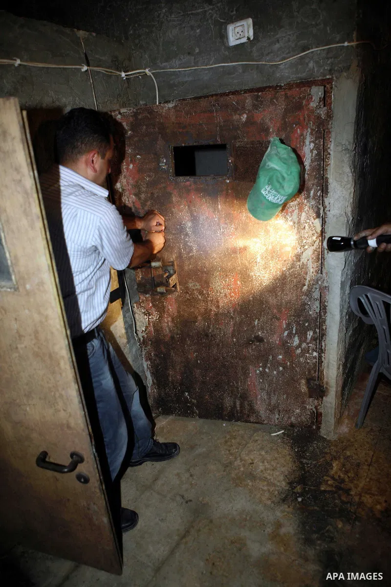 Palestinian plain clothed security inspects a room built under a house in the West Bank village of Urif, south of the northern city of Nablus on September 23, 2012. Palestinian security believe a network of tunnels, room...
