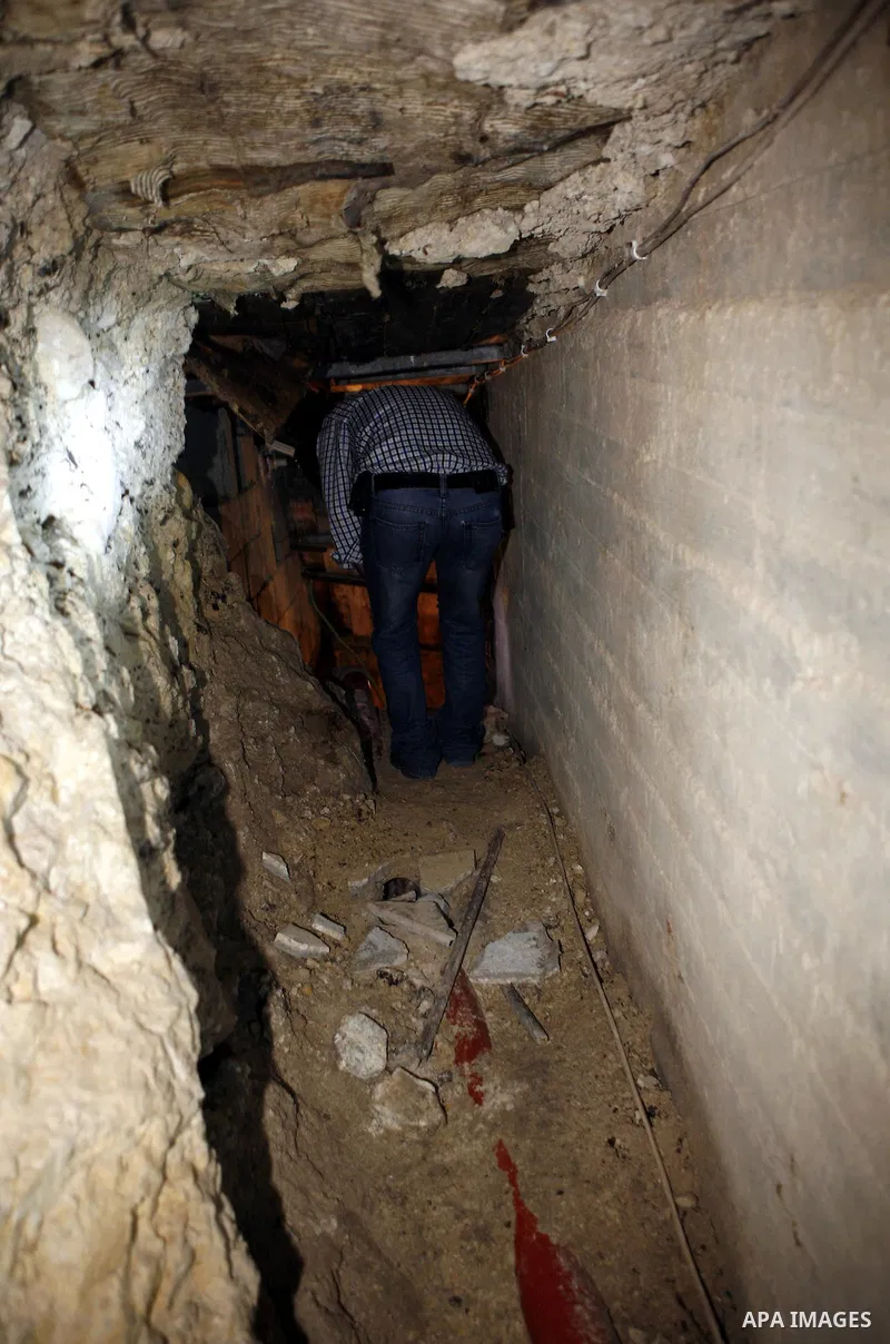 A Palestinian security officer walks down stairs leading to tunnels dug under a house in the West Bank village of Urif, south of the northern city of Nablus on September 23, 2012. Palestinian security believe the tunnels...