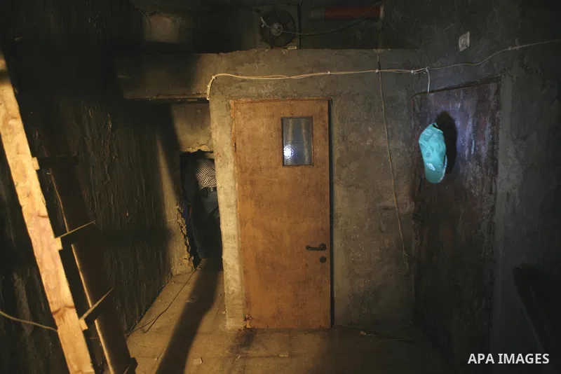 Palestinian plain clothed security inspects a room built under a house in the West Bank village of Urif, south of the northern city of Nablus on September 23, 2012. Palestinian security believe a network of tunnels, room...