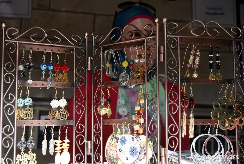 A Palestinian youth displays traditional handmade during the Jerusalemite cakes festival in al-Sheikh Jarrah neighborhood in the east of Jerusalem city, on 23 September 2012. Photo by Mahfouz Abu Turk