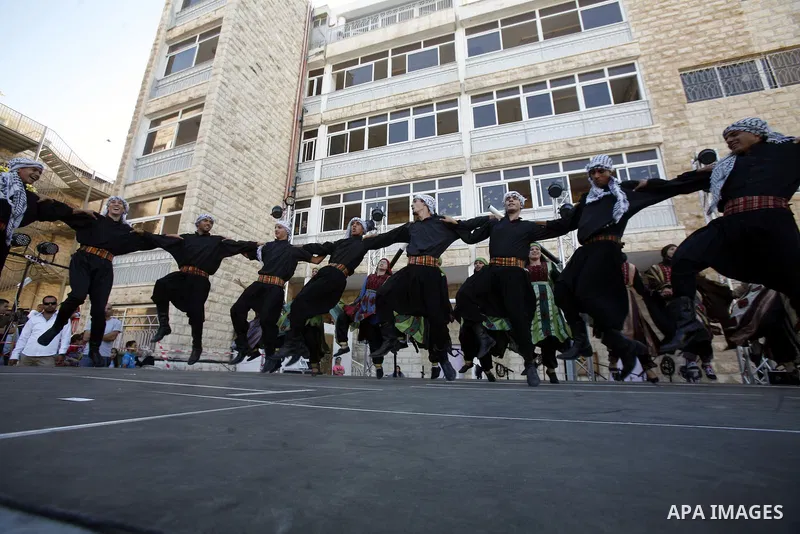 Palestinians perform dances during the Jerusalemite cakes festival in al-Sheikh Jarrah neighborhood in the east of Jerusalem city, on 23 September 2012. Photo by Mahfouz Abu Turk