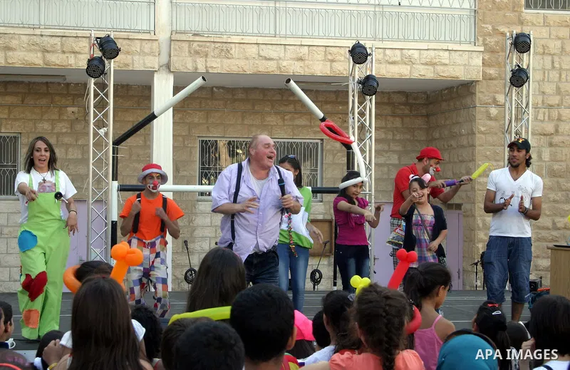 Palestinians perform dances during the Jerusalemite cakes festival in al-Sheikh Jarrah neighborhood in the east of Jerusalem city, on 23 September 2012. Photo by Mahfouz Abu Turk