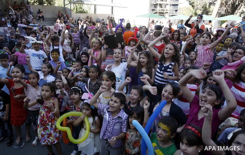 Palestinian children attend the Jerusalemite cakes festival in al-Sheikh Jarrah neighborhood in the east of Jerusalem city, on 23 September 2012. Photo by Mahfouz Abu Turk