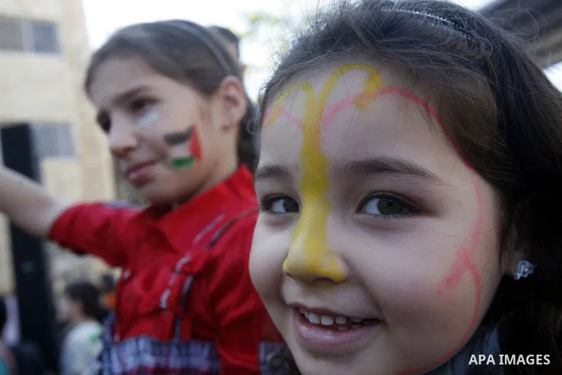 A Palestinian girl attends the Jerusalemite cakes festival in al-Sheikh Jarrah neighborhood in the east of Jerusalem city, on 23 September 2012. Photo by Mahfouz Abu Turk