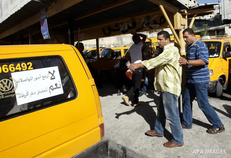 Palestinian taxi drivers park their cars during a protest against rising fuel prices and the high cost of living, in the West Bank city of Nablus, Sept. 24, 2012. Photo by Nedal Eshtayah