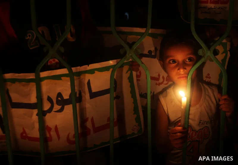 A Palestinian boy holds a candle during a rally to show solidarity with Syrian mothers and children who suffer most in civil war, in Jabalia refugee camp northen Gaza strip, September 24, 2012. The UN Security Council sh...
