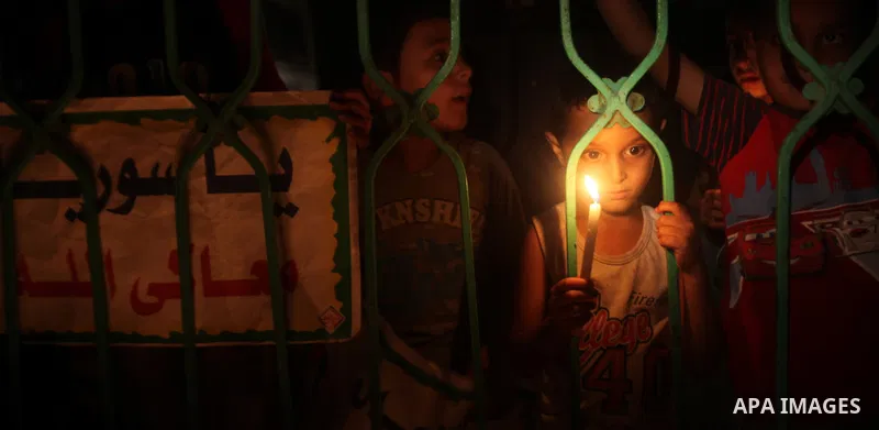 A Palestinian boy holds a candle during a rally to show solidarity with Syrian mothers and children who suffer most in civil war, in Jabalia refugee camp northen Gaza strip, September 24, 2012. The UN Security Council sh...