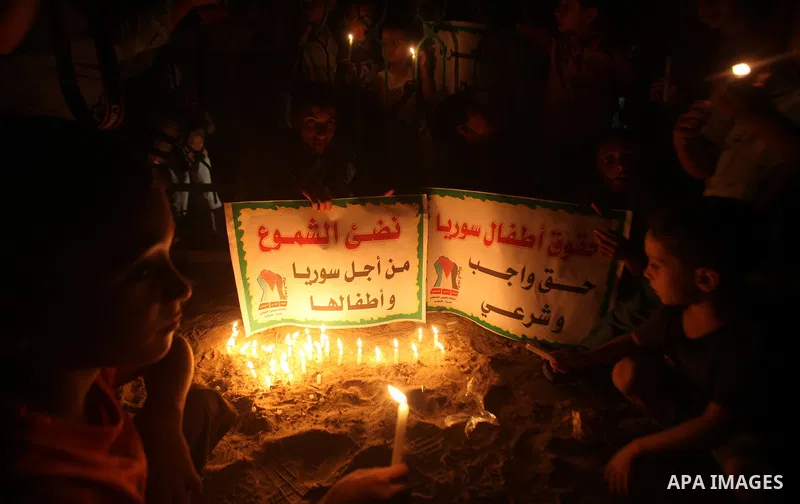 Palestinian children lite candles during a rally to show solidarity with Syrian mothers and children who suffer most in civil war, in Jabalia refugee camp northen Gaza strip, September 24, 2012. The UN Security Council s...