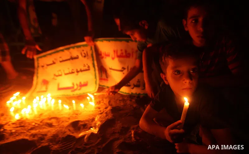 Palestinian children lite candles during a rally to show solidarity with Syrian mothers and children who suffer most in civil war, in Jabalia refugee camp northen Gaza strip, September 24, 2012. The UN Security Council s...