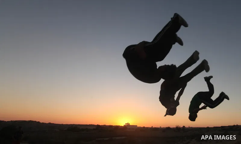 Palestinian youths practice their parkour skills in Khan Younis in southern Gaza Strip on 24 September 2012. Parkour originating in France is the physical practice of traversing elements in both urban and rural settings...
