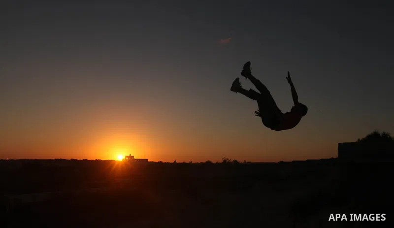 Palestinian youths practice their parkour skills in Khan Younis in southern Gaza Strip on 24 September 2012. Parkour originating in France is the physical practice of traversing elements in both urban and rural settings...