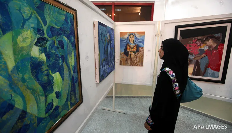 A Palestinian youth looks at paintings during an abstract painting show in Gaza city, on 24 September 2012. Photo by Majdi Fathi
