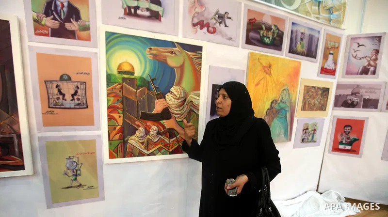A Palestinian youth looks at paintings during an abstract painting show in Gaza city, on 24 September 2012. Photo by Majdi Fathi
