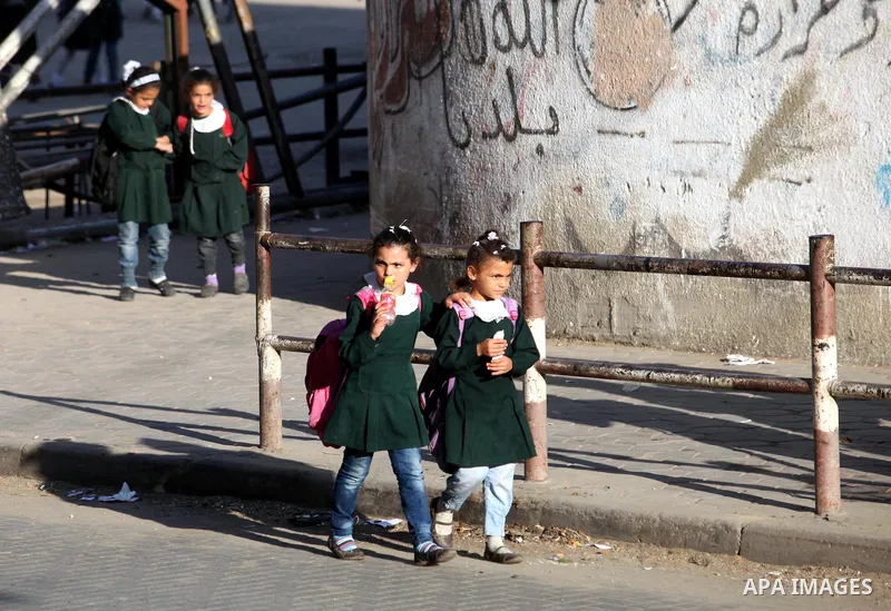 Palestinian students back from their school after a study day in al-Shijaia in the east of Gaza city, Sept. 25, 2012. Gazans suffer with the power outage on varying periods which affects adversely on the educational and...