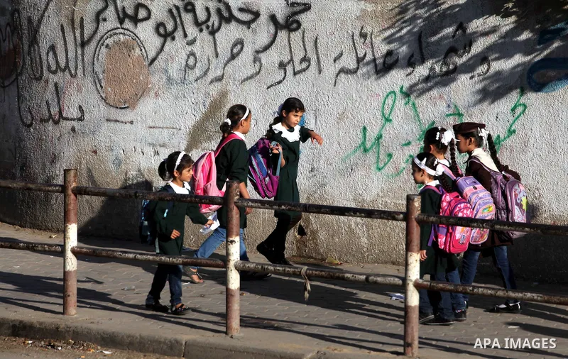 Palestinian students back from their school after a study day in al-Shijaia in the east of Gaza city, Sept. 25, 2012. Gazans suffer with the power outage on varying periods which affects adversely on the educational and...