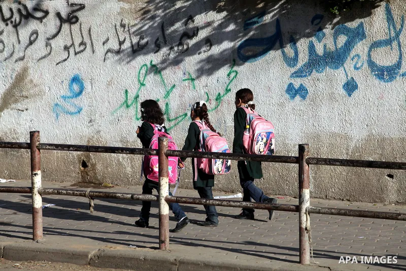 Palestinian students back from their school after a study day in al-Shijaia in the east of Gaza city, Sept. 25, 2012. Gazans suffer with the power outage on varying periods which affects adversely on the educational and...