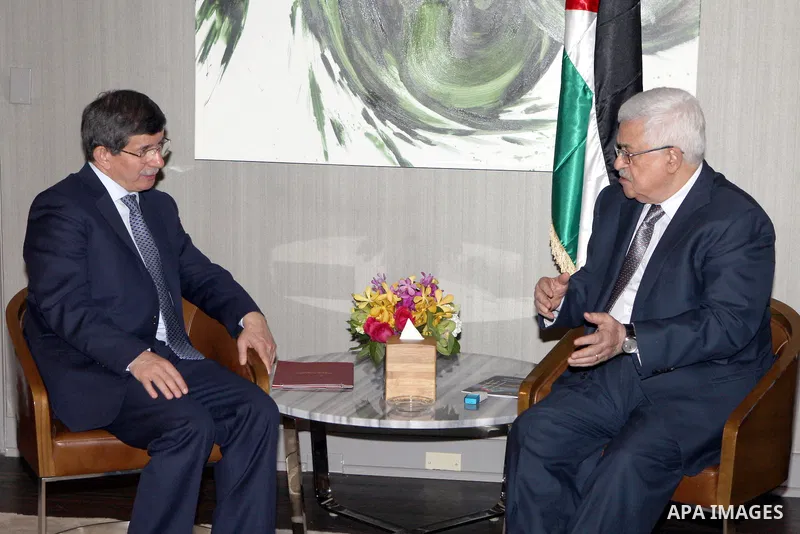 Palestinian President Mahmoud Abbas meets with Turkish Foreign Minister Ahmet Davutoglu, in New York, on Sept. 25, 2012. Photo by Thaer Ganaim