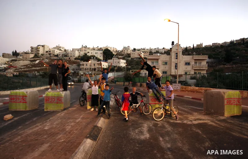 Palestinian children ride their bicycles during closing the roads between the Israeli settlements and the Arab neighborhoods by the Israeli border police in Jerusalem's old city, Sept. 25, 2012. Closes early for Yom Kipp...