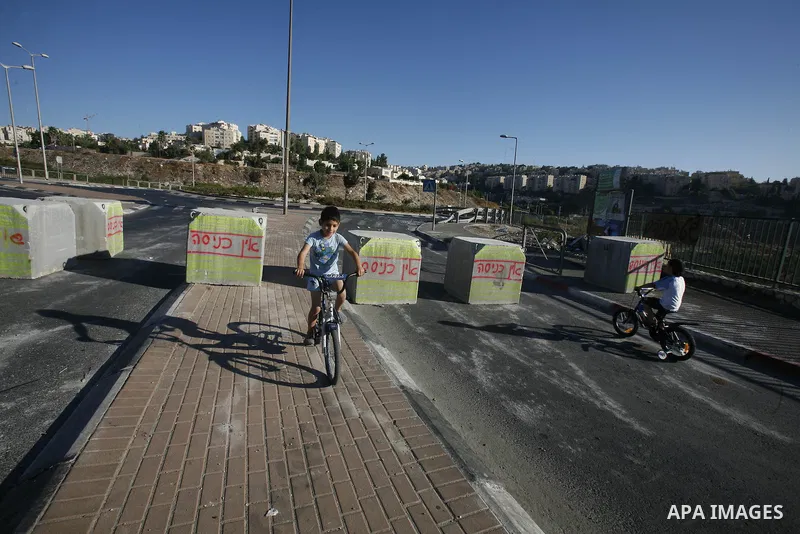 Palestinian children ride their bicycles during closing the roads between the Israeli settlements and the Arab neighborhoods by the Israeli border police in Jerusalem's old city, Sept. 26, 2012. Closes early for Yom Kipp...