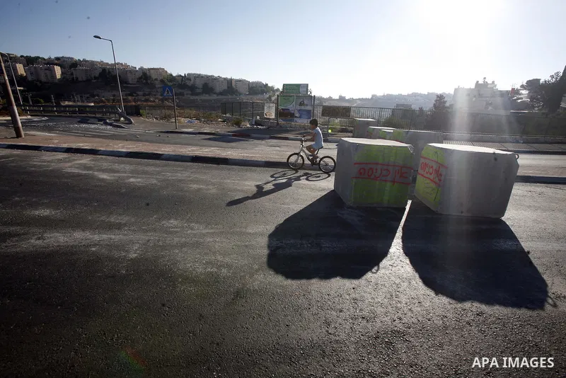 Palestinian children ride their bicycles during closing the roads between the Israeli settlements and the Arab neighborhoods by the Israeli border police in Jerusalem's old city, Sept. 26, 2012. Closes early for Yom Kipp...