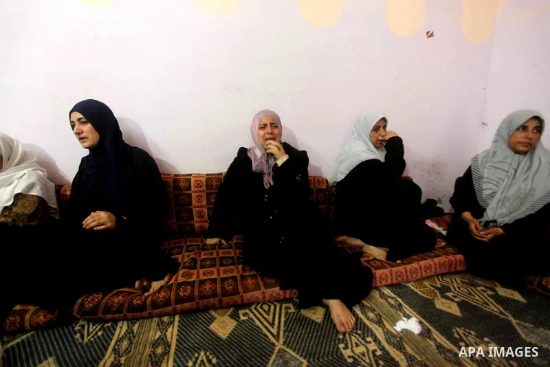 Palestinian relatives of one-year-old Fathi Baghdadi weeps, who died after a fire from a candle that swept through their home in the Bureij refugee camp in the center of the Gaza Strip on September 26, 2012. The Baghdadi...