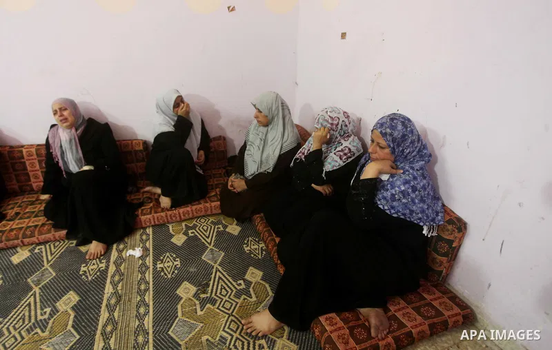 Palestinian relatives of one-year-old Fathi Baghdadi weeps, who died after a fire from a candle that swept through their home in the Bureij refugee camp in the center of the Gaza Strip on September 26, 2012. The Baghdadi...
