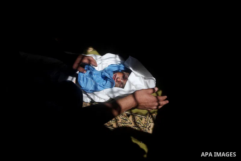 The body of three-year-old Fathi Baghdadi, who was killed in an overnight domestic fire, lies on a couch at his home in the Bureij refugee camp, centeral Gaza Strip, on September 26, 2012. The boy was found dead while hi...