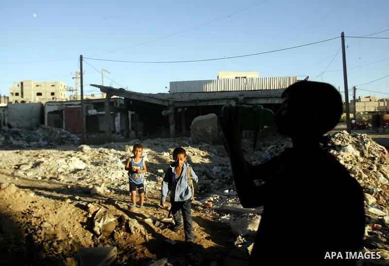 Palestinian children stand near an erupting sewage pipeline, in Rafah refugee camp southern the Gaza strip, Sept 26, 2012. In the aftermath of the Israeli military Operation Cast Lead in 2008/2009, Palestinian refugees i...